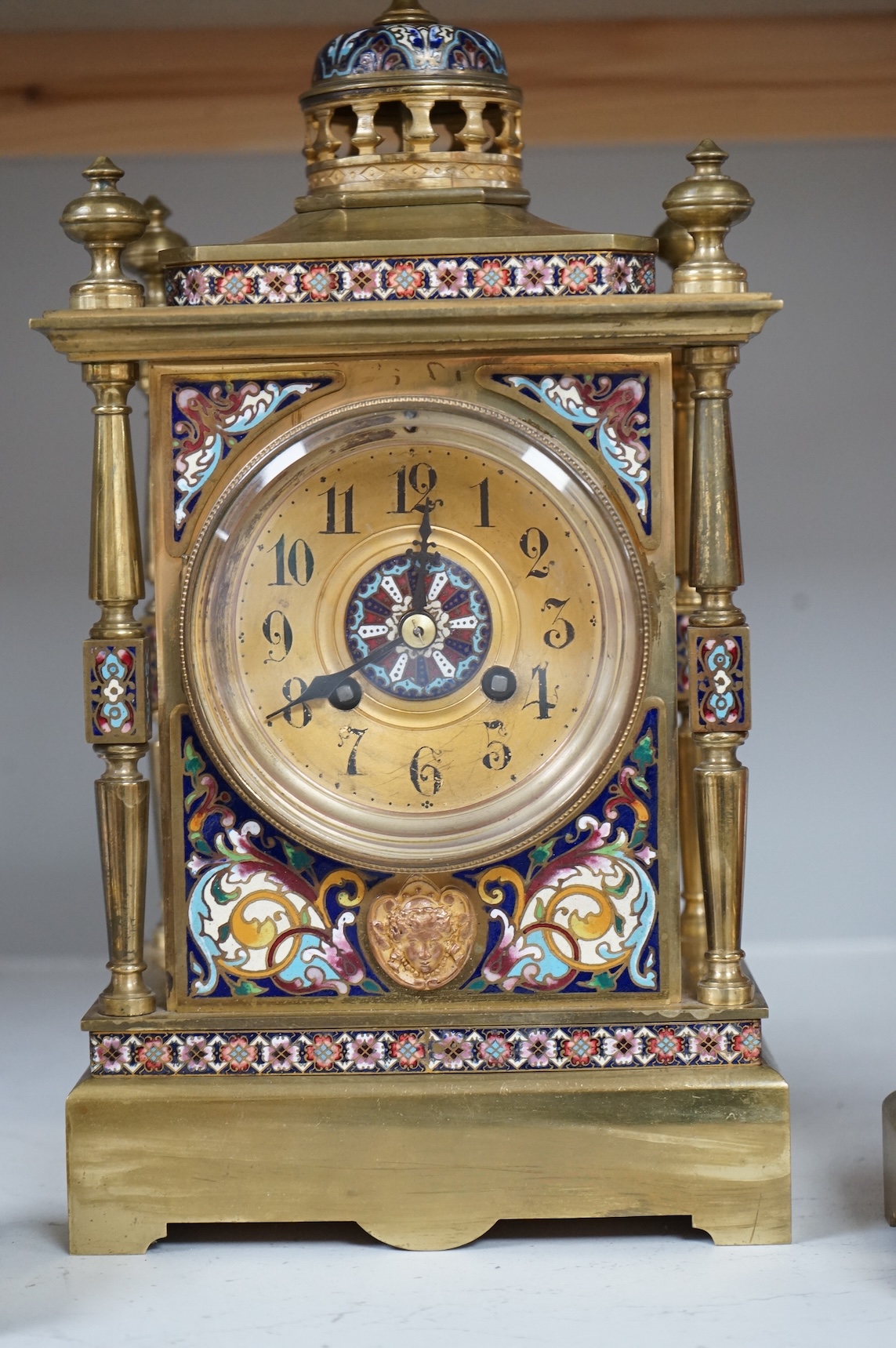A large early 20th century French brass and champlevé enamel clock garniture, 35cm high